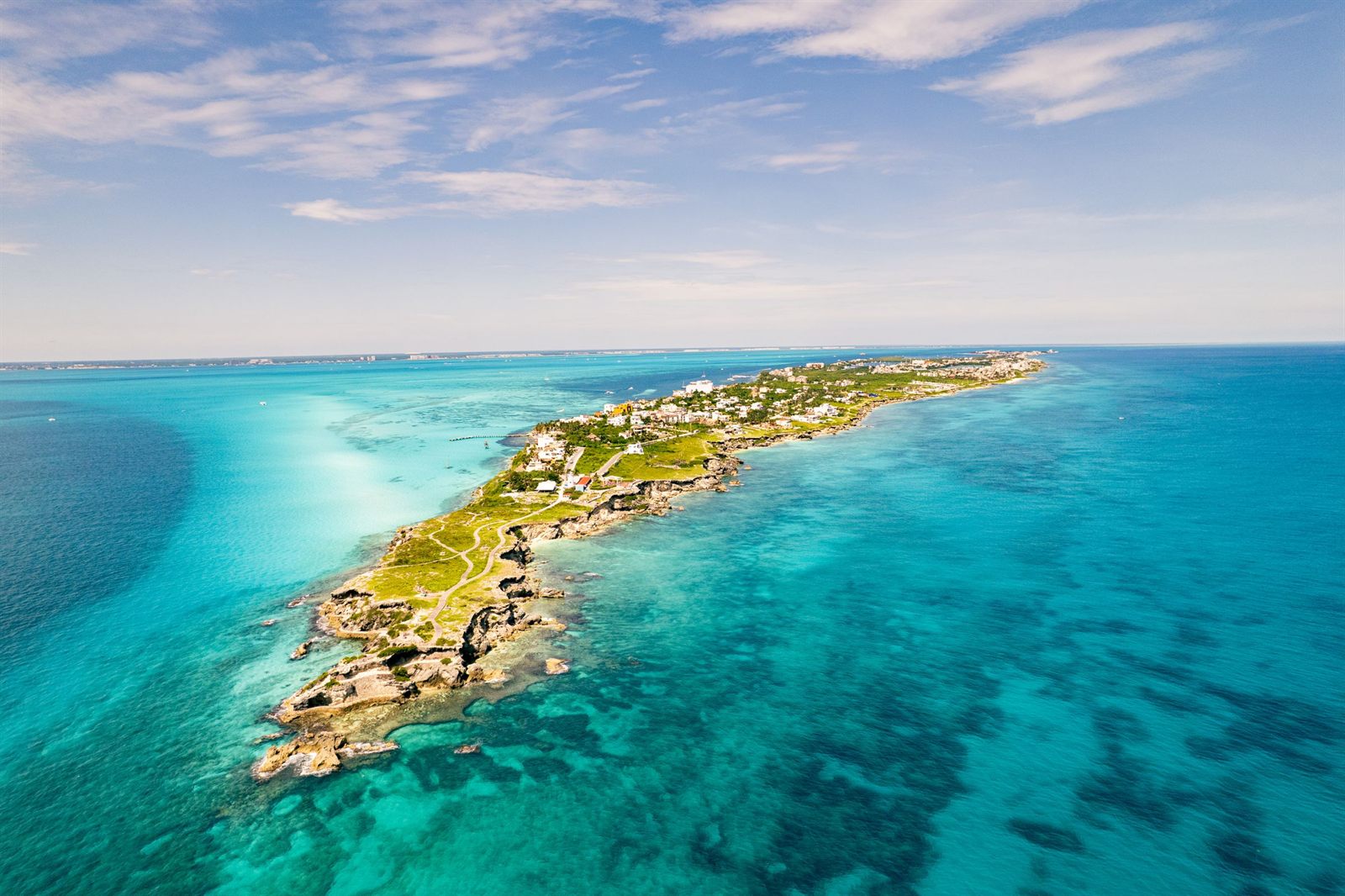 Aerial view of a narrow island surrounded by turquoise water